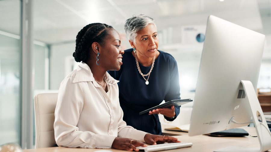 Two colleagues reviewing operations on screen